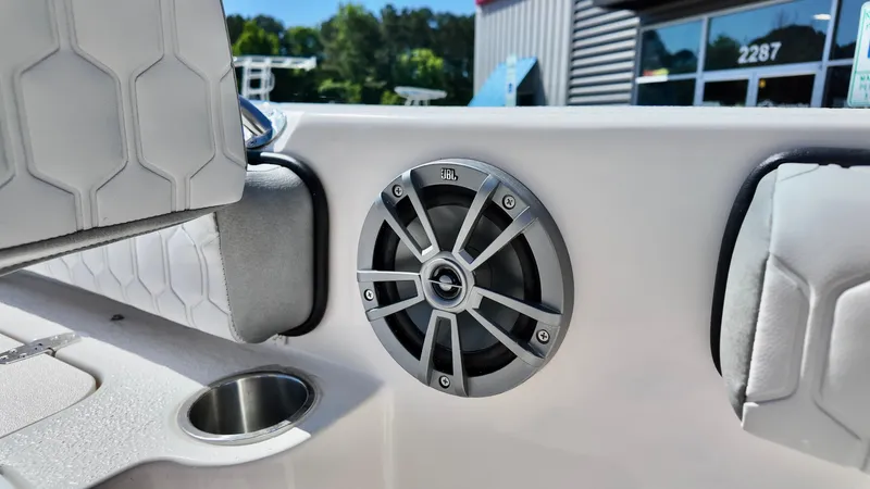 Slide: The Image of 2025 Carolina Skiff 24 Ultra Elite boat interior with speaker and cup holder. - 13