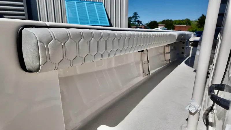 Slide: The Image of 2025 Carolina Skiff 24 Ultra Elite boat interior with hexagonal-patterned upholstery. - 14