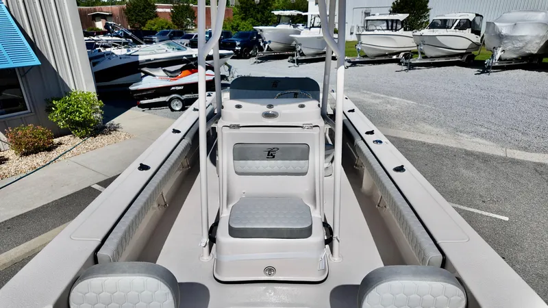Slide: The Image of 2025 Carolina Skiff 24 Ultra Elite boat interior with seating and console, displayed outdoors. - 15