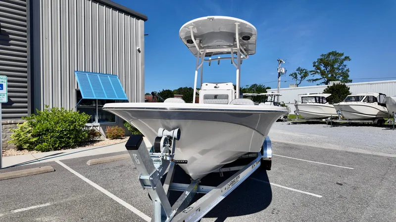 Slide: The Image of 2025 Carolina Skiff 24 Ultra Elite boat on trailer in parking lot. - 4