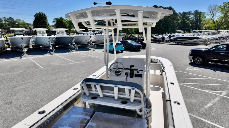 Slide: The Image of 2025 Carolina Skiff 24 Ultra Elite boat in a dealership lot, showcasing helm and seating area. - 6