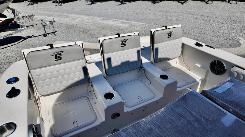 Slide: The Image of 2025 Carolina Skiff 24 Ultra Elite boat seating with storage and cup holders. - 8