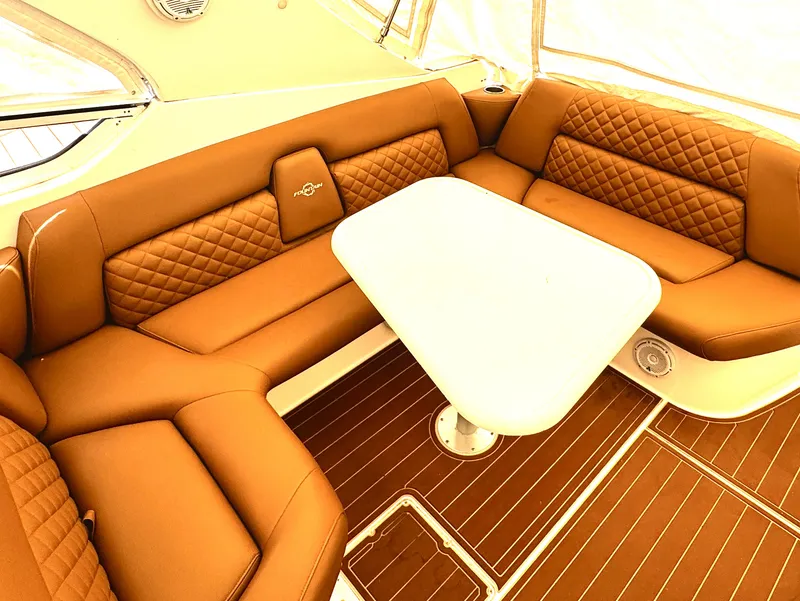 Slide: The Image of Luxurious seating area on 2005 Fountain 48 Express Cruiser with brown leather upholstery. - 11