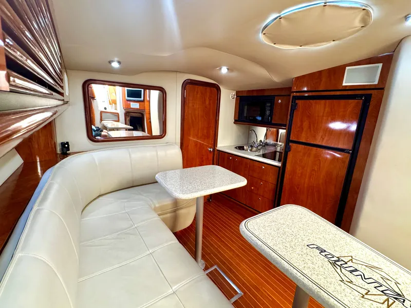 Slide: The Image of Luxurious interior of 2005 Fountain 48 Express Cruiser with leather seating and kitchenette. - 13