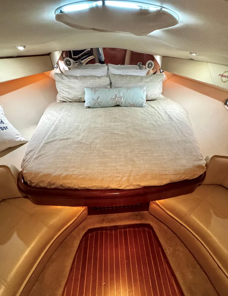 Slide: The Image of Luxurious cabin interior of 2005 Fountain 48 Express Cruiser with cozy bedding. - 14