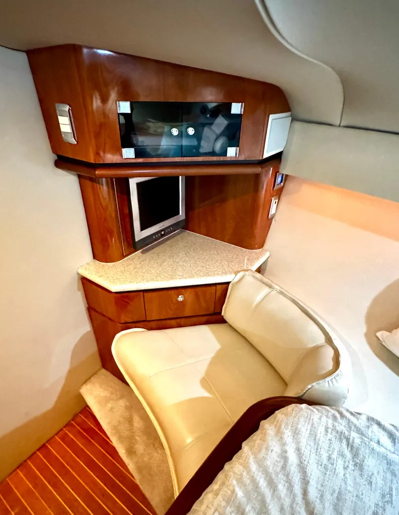 Slide: The Image of Luxurious interior of 2005 Fountain 48 Express Cruiser with wood cabinetry and seating. - 16