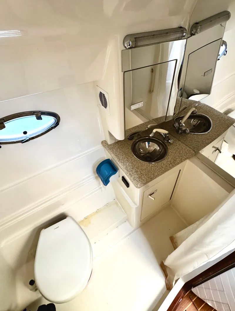 Slide: The Image of 2005 Fountain 48 Express Cruiser bathroom with sink, toilet, and mirror. - 17