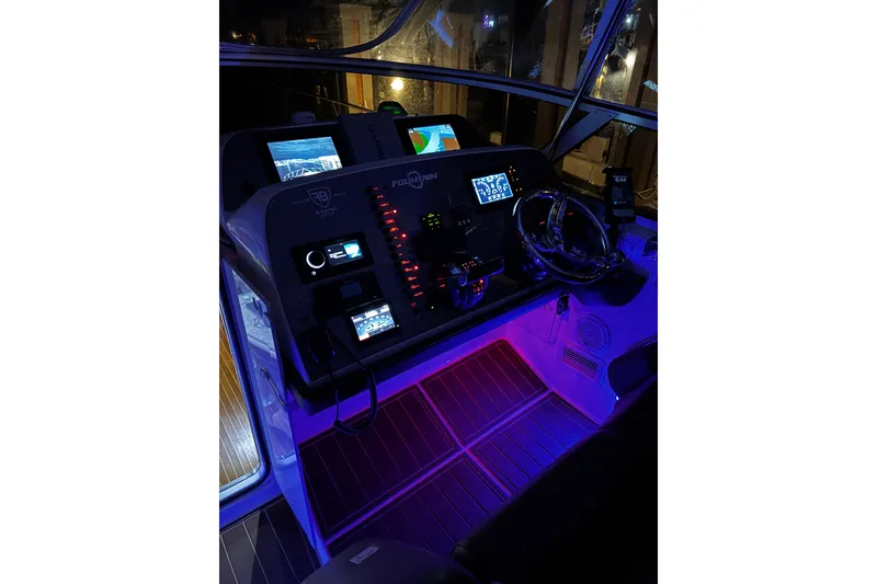 Slide: The Image of 2005 Fountain 48 Express Cruiser cockpit with illuminated controls and navigation screens. - 18