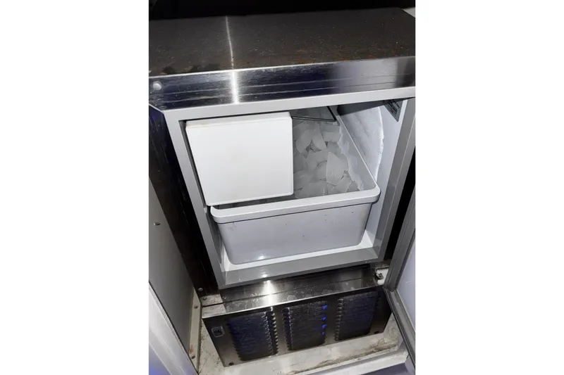 Slide: The Image of Ice maker inside a 2005 Fountain 48 Express Cruiser yacht, filled with ice cubes. - 21