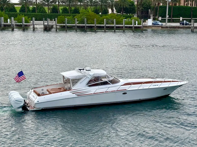 Slide: The Image of 2005 Fountain 48 Express Cruiser yacht on calm water, American flag displayed. - 3