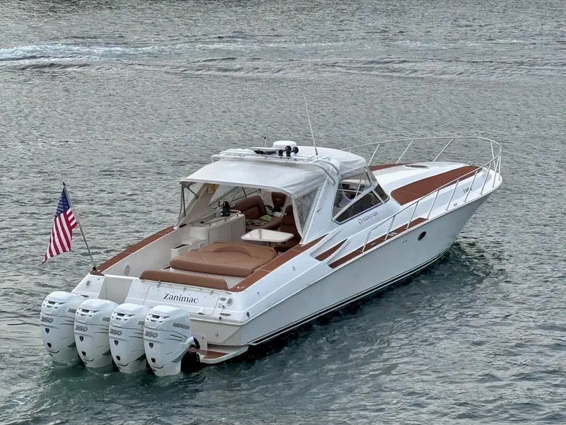 Slide: The Image of 2005 Fountain 48 Express Cruiser on water, featuring four outboard engines and an American flag. - 4