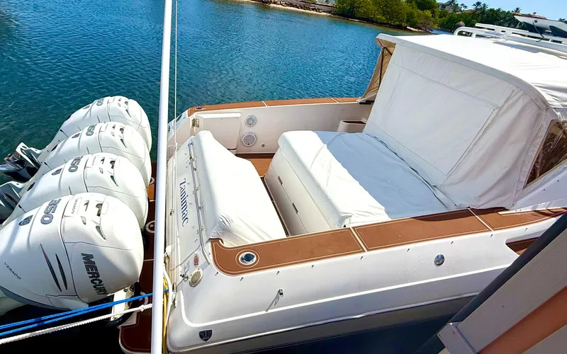 Slide: The Image of 2005 Fountain 48 Express Cruiser with triple Mercury engines docked by the water. - 7