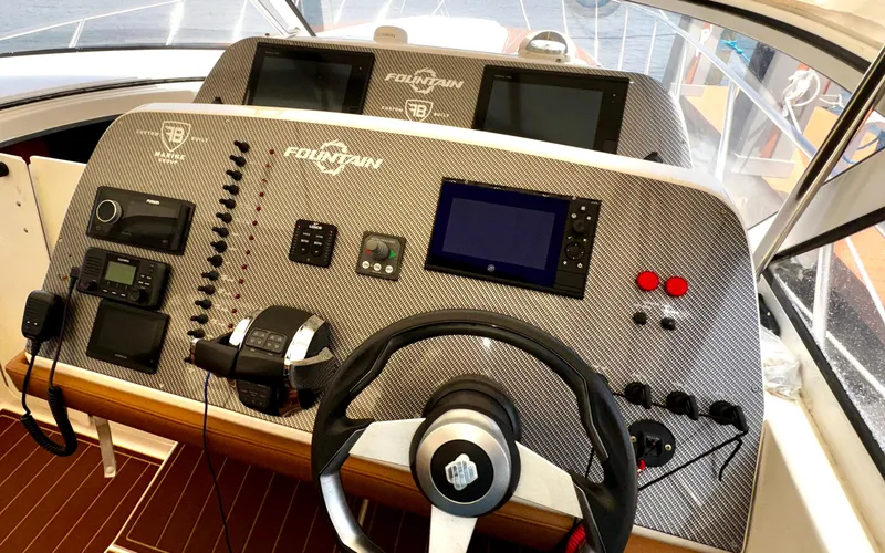 Slide: The Image of Control panel of a 2005 Fountain 48 Express Cruiser with navigation equipment. - 9