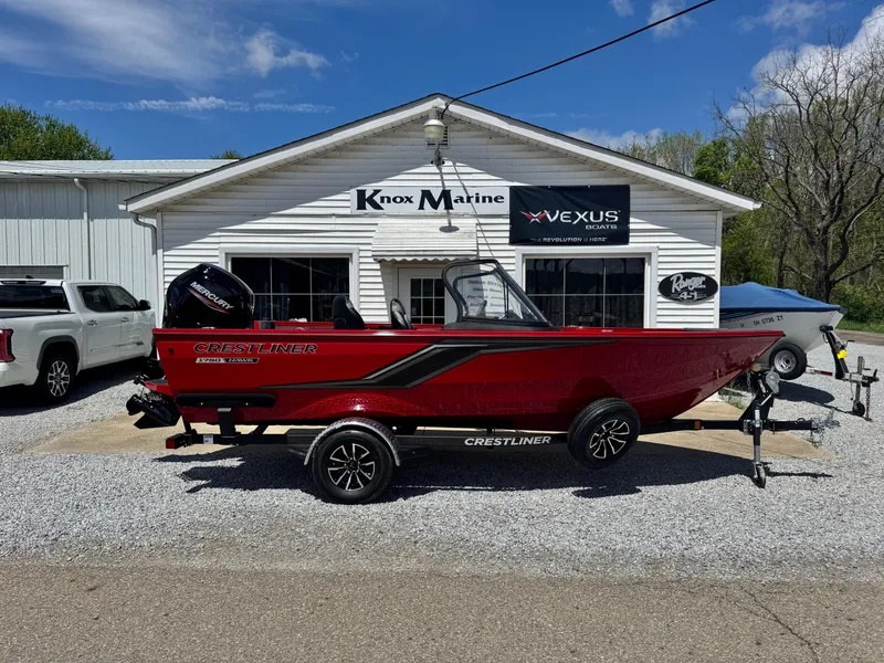 Slide: The Image of 2025 Crestliner 1750 Hawk boat in red, parked outside Knox Marine dealership. - 1