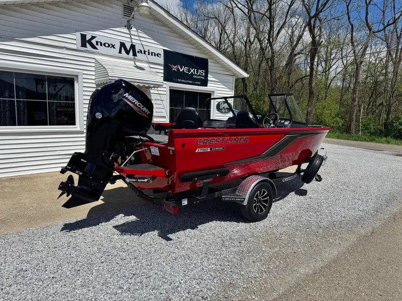 Slide: The Image of 2025 Crestliner 1750 Hawk boat in red, parked outside Knox Marine dealership. - 3