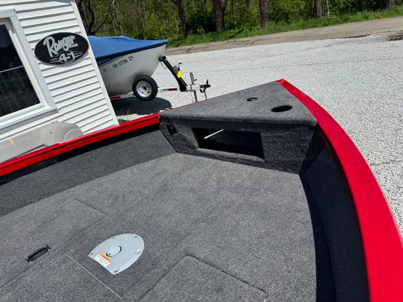 Slide: The Image of 2025 Crestliner 1750 Hawk boat interior with red trim and carpeted deck. - 7