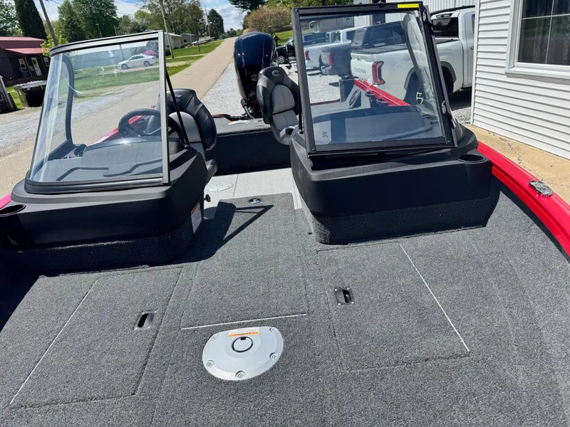 Slide: The Image of 2025 Crestliner 1750 Hawk boat interior with dual consoles and carpeted deck. - 8