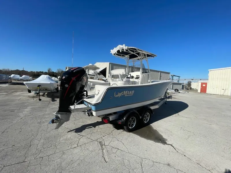 Slide: The Image of 2025 Mako 214 Center Console boat on trailer in sunny outdoor setting. - 0