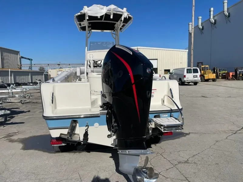 Slide: The Image of 2025 Mako 214 Center Console boat with powerful outboard motor, parked outdoors. - 11