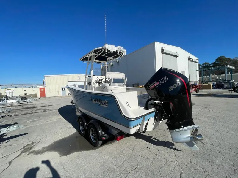 Slide: The Image of 2025 Mako 214 Center Console boat with powerful outboard motor on a trailer. - 2