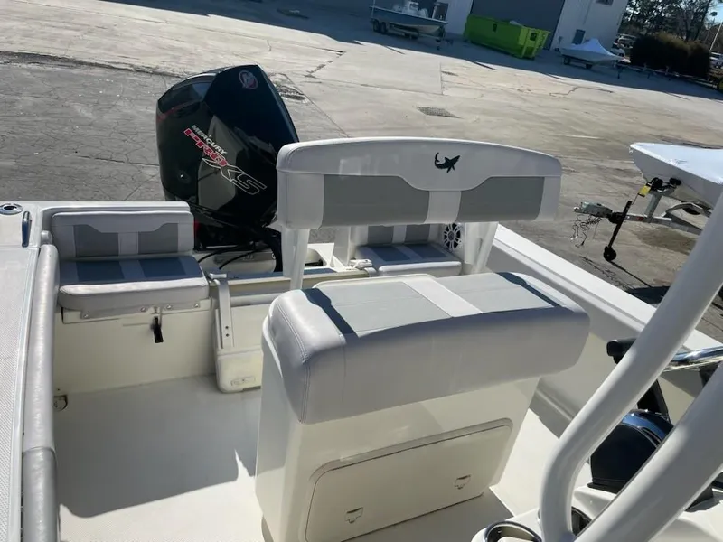 Slide: The Image of 2025 Mako 214 Center Console boat interior with seating and outboard motor. - 7