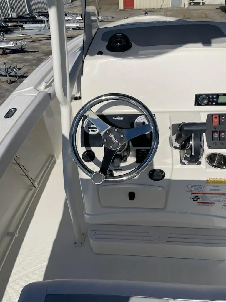 Slide: The Image of 2025 Mako 214 Center Console boat steering wheel and control panel. - 8