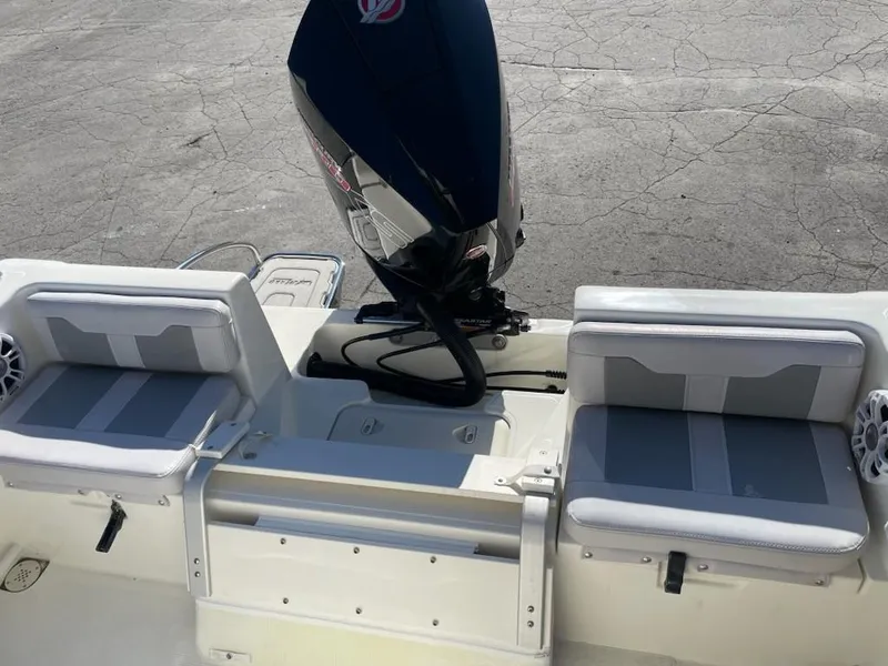 Slide: The Image of 2025 Mako 214 Center Console boat with dual seating and outboard motor. - 9