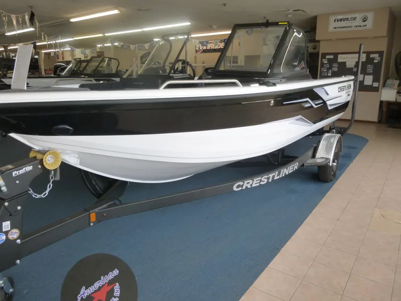 Slide: The Image of 2024 Crestliner 1850 SPORT FISH boat displayed indoors on a trailer. - 8