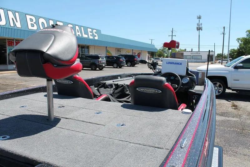 Slide: The Image of 2023 Phoenix 921 Elite II boat at dealership, featuring spacious deck and seating. - 13