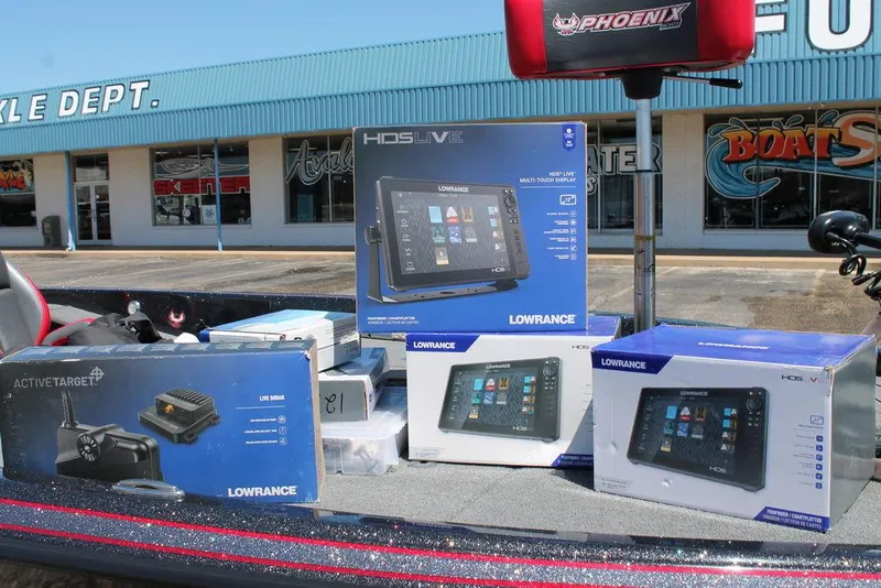 Slide: The Image of Boxes of Lowrance electronics on a Phoenix 921 Elite II boat, 2023 model, outside a tackle shop. - 3
