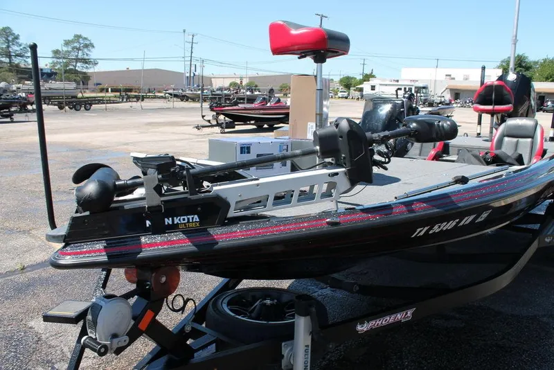 Slide: The Image of 2023 Phoenix 921 Elite II boat with Minn Kota trolling motor in a parking lot. - 5