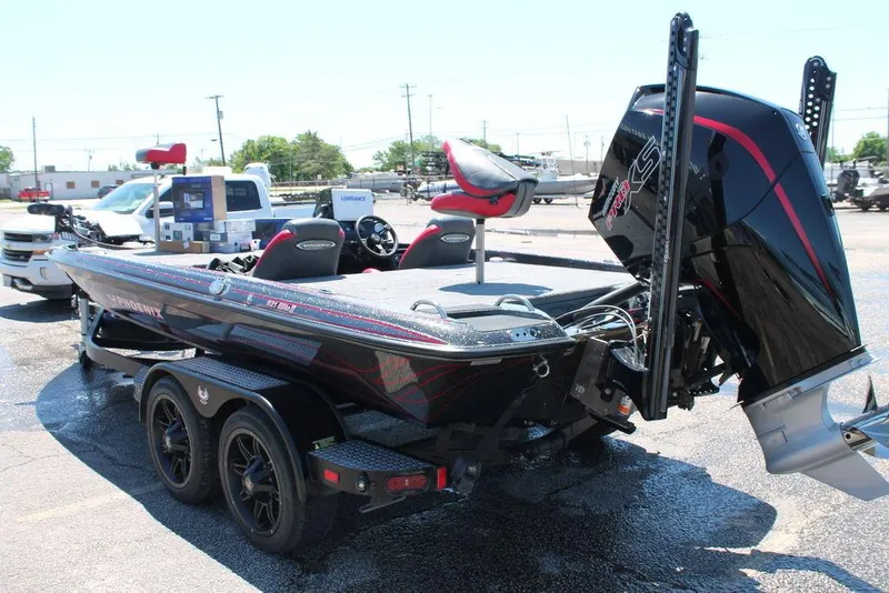 Slide: The Image of 2023 Phoenix 921 Elite II boat on trailer, featuring sleek design and powerful outboard motor. - 7