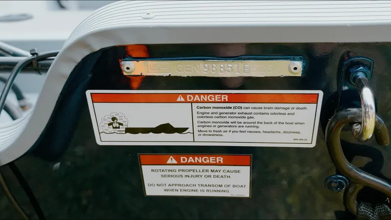 Slide: The Image of Danger warning labels on 2025 G3 Guide V187 T boat, highlighting carbon monoxide and propeller risks. - 11