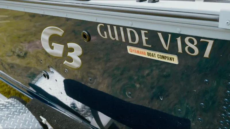 Slide: The Image of 2025 G3 Guide V187 T boat with Yamaha branding, close-up view. - 12