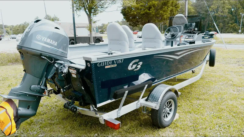 Slide: The Image of 2025 G3 Guide V187 T boat on trailer with Yamaha outboard motor. - 13