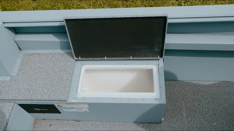 Slide: The Image of 2025 G3 Guide V187 T boat storage compartment with open lid, showcasing interior space. - 3