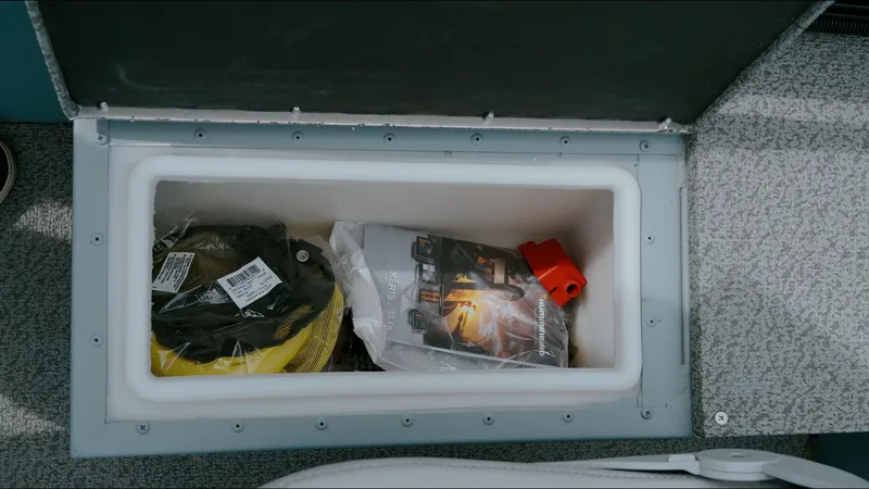Slide: The Image of Storage compartment in 2025 G3 Guide V187 T boat, containing equipment and accessories. - 5