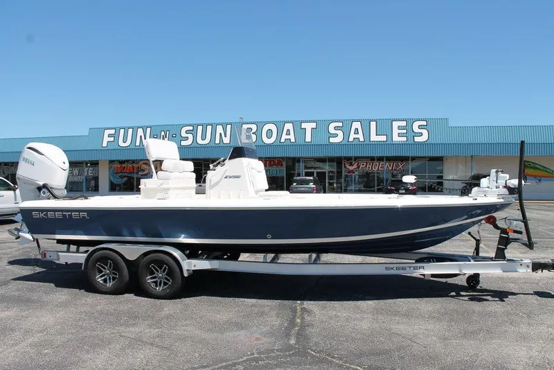 Slide: The Image of 2025 Skeeter SX241 boat on trailer at Fun-N-Sun Boat Sales dealership. - 0