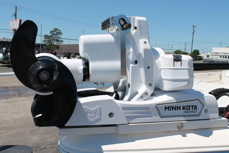 Slide: The Image of Minn Kota Instinct motor on 2025 Skeeter SX241 boat, outdoor setting. - 11