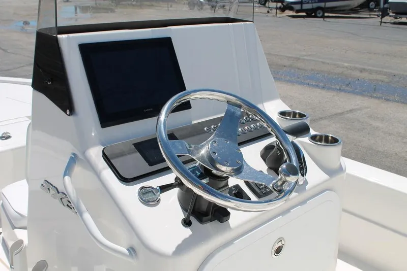 Slide: The Image of 2025 Skeeter SX241 boat console with steering wheel and digital display. - 8
