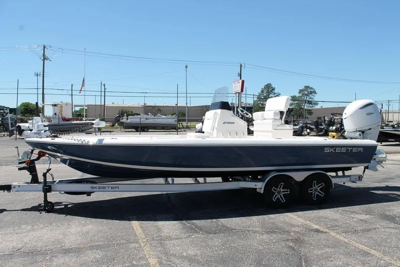 Slide: The Image of 2025 Skeeter SX241 boat on trailer in parking lot, side view. - 9