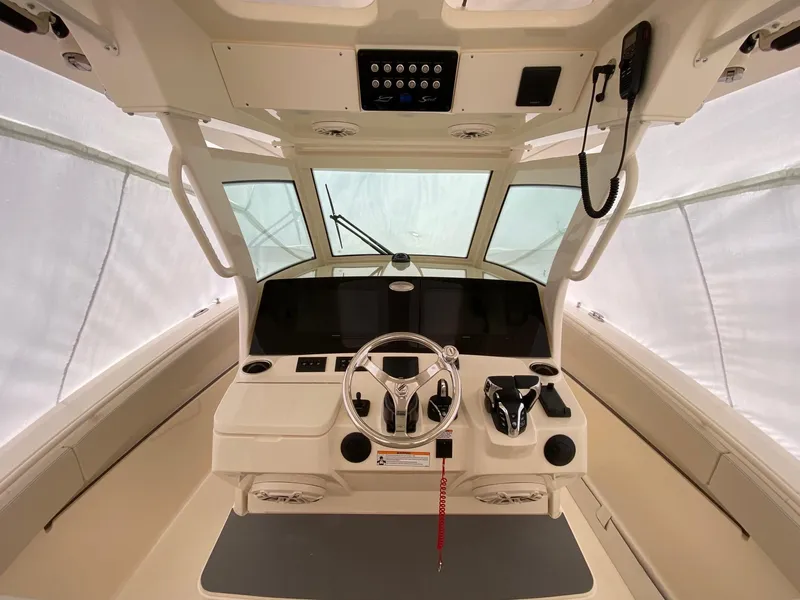 Slide: The Image of 2026 Scout 357 LXF boat helm with modern controls and steering wheel. - 3
