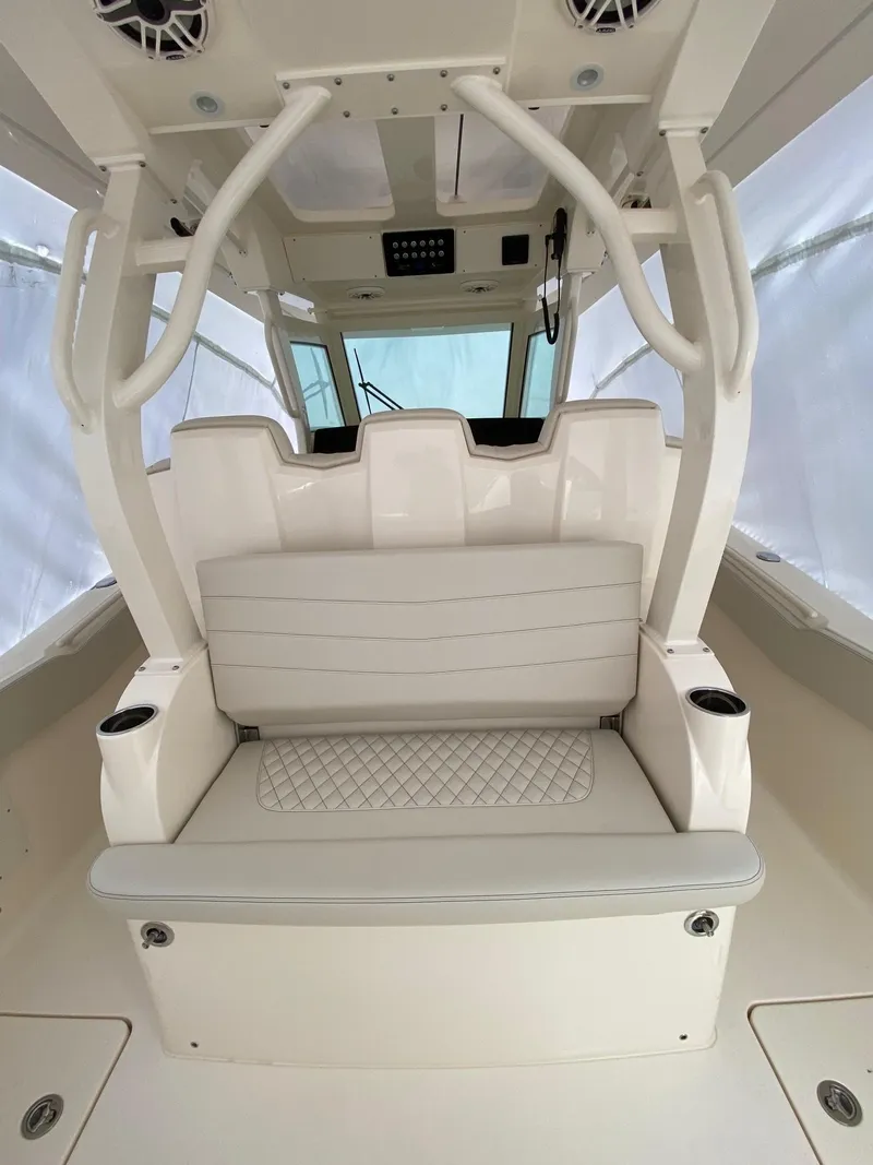 Slide: The Image of 2026 Scout 357 LXF boat interior with white seating and cup holders. - 6