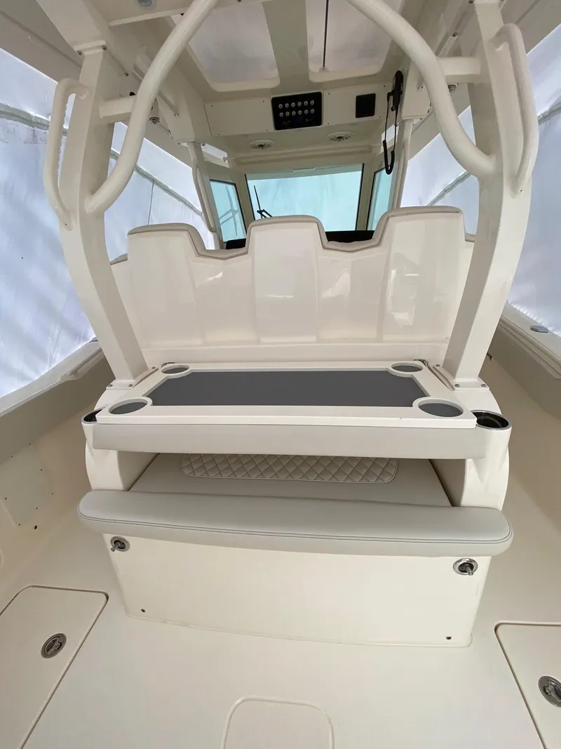 Slide: The Image of 2026 Scout 357 LXF boat interior with seating and cup holders. - 7