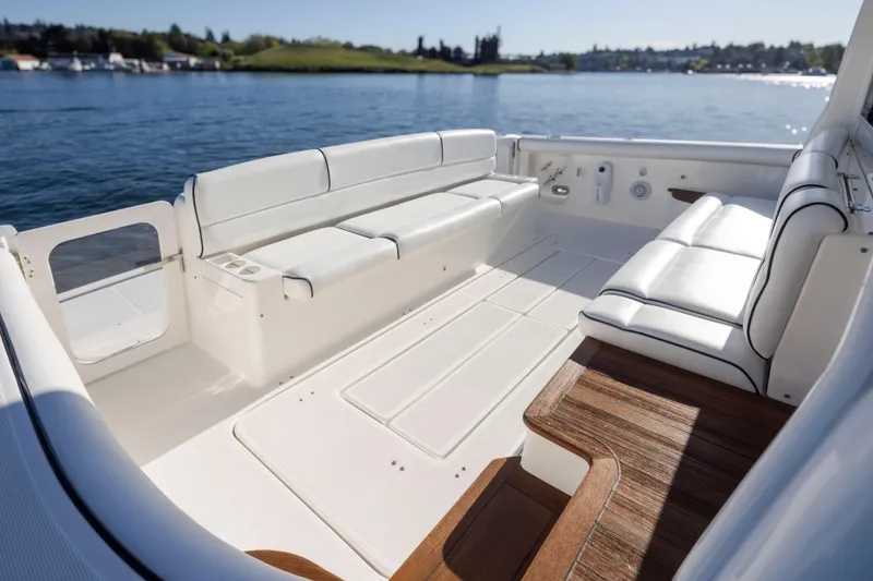 Slide: The Image of 2005 Tiara Yachts 5200 Sovran Salon with spacious white seating on a sunny day. - 14