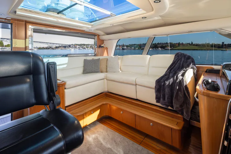 Slide: The Image of Luxurious interior of 2005 Tiara Yachts 5200 Sovran Salon with white leather seating and scenic view. - 16