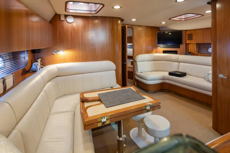 Slide: The Image of Luxurious interior of 2005 Tiara Yachts 5200 Sovran Salon with plush seating and wooden accents. - 23