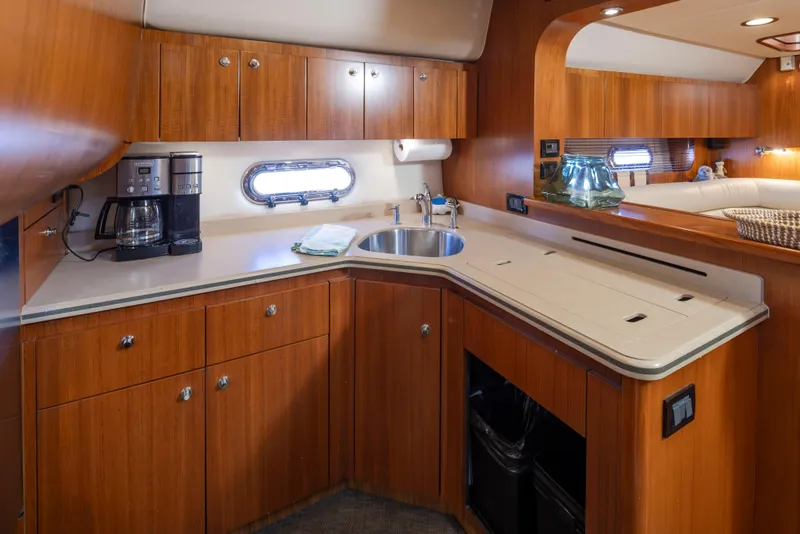 Slide: The Image of Luxurious 2005 Tiara Yachts 5200 Sovran Salon kitchen with wood cabinetry and modern amenities. - 25