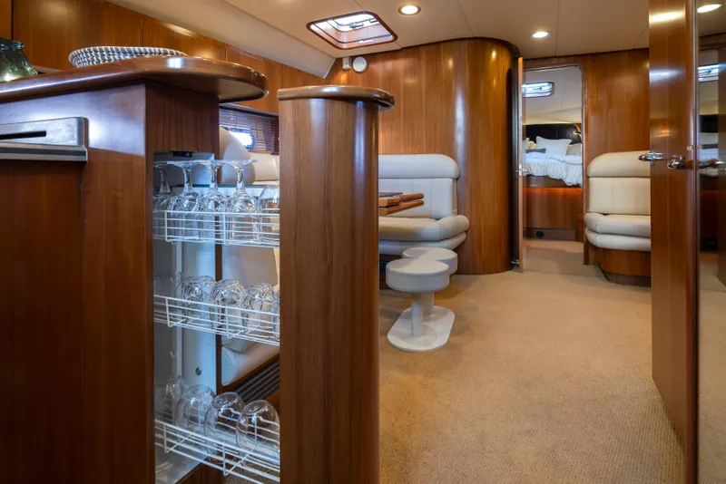 Slide: The Image of Luxurious interior of 2005 Tiara Yachts 5200 Sovran Salon with elegant wood finish and seating. - 29