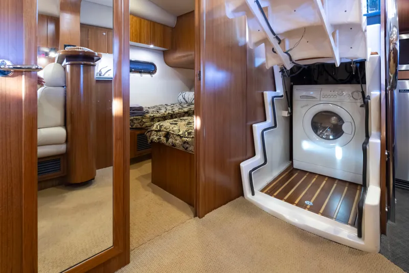 Slide: The Image of Interior of 2005 Tiara Yachts 5200 Sovran Salon with washer and cozy cabin. - 32